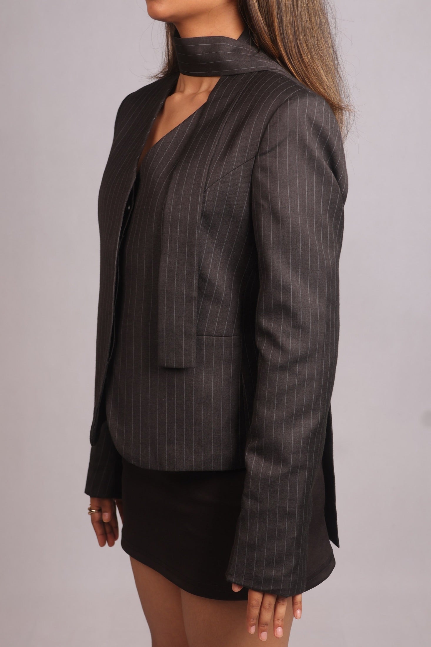Model wearing the SEANT 009 pinstripe scarf blazer, side view