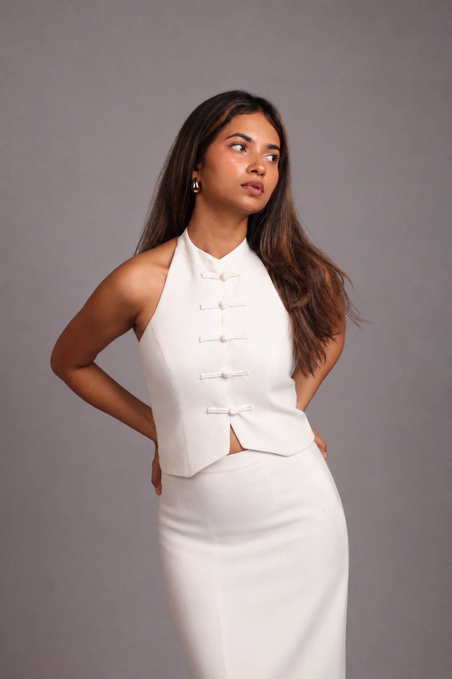 Model wearing the SEANT 008 column maxi skirt in ivory